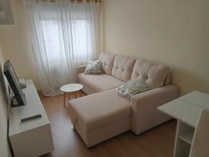 a living room with a white couch and a table at Donato in Gijón