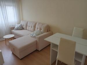 a living room with a white couch and a table at Donato in Gijón