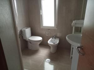 a bathroom with a toilet and a sink at Donato in Gijón +10 photos