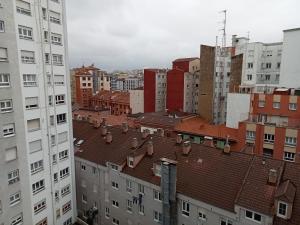 a view of a city with buildings and roofs at Donato in Gijón