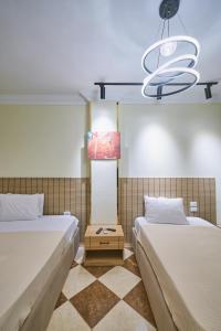 a bedroom with two beds and a chandelier at Pyramids Stars Egypt in Cairo