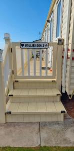a house with a gate with a sign that reads mauldias drew at MOLLIES DEN 2 8 Berth 3 Bedrooms The Grange Holiday Park INGOLDMELLS in Ingoldmells