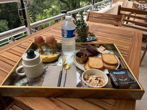 a tray with bread and eggs and a bottle of water at Agréable chambre et salle de bain privée dans notre appartement partagé in Cannes