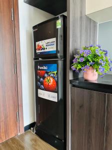 a black refrigerator with a box of fruit on it at Khách sạn LAzur Cửa Lò- Nghệ An in Giáp Vinh Yên