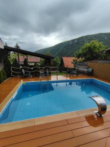 a swimming pool with a mountain in the background at Vikendica sa bazenom"Mila"Banja Topilo in Banja Topilo