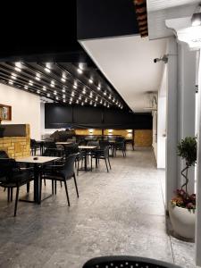 a dining room with tables and chairs and lights at Hotel Elite in Ksamil