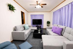 a living room with two couches and a tv at HORIKIRI House TOKYO in Tokyo