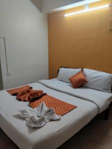 two beds sitting next to each other in a room at R K Residency Formerly Gamas in Trivandrum