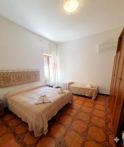 a bedroom with a large bed with towels on it at Casa dei mille in Castelsardo