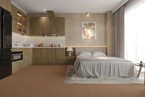 a bedroom with a bed and a kitchen at Grand Central Hotel- Vinhomes Ocean Park 3 in Ðình Loan