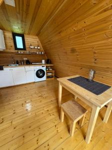 a wooden room with a table and a kitchen at Hochaladah2 in Mestia +5 photos