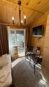 a living room with a couch and a tv in a room at GSpace in Yaremche