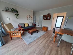 a living room with a couch and a table at 5 Ysterklip Close, Hermanus in Hermanus