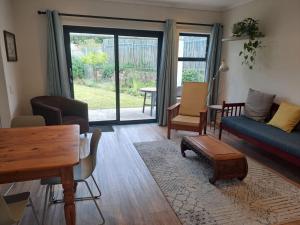 a living room with a couch and a table at 5 Ysterklip Close, Hermanus in Hermanus