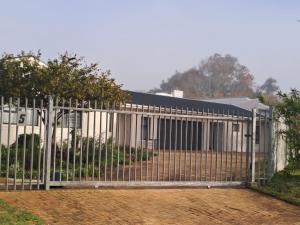 a metal gate in front of a building at 5 Ysterklip Close, Hermanus in Hermanus +4 photos