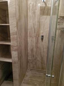 a shower with a glass door in a bathroom at Cyprysowa 7 in Kiełczów +14 photos