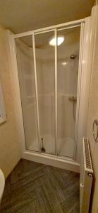 a shower with a glass door in a bathroom at MOLLIES DEN 2 8 Berth 3 Bedrooms The Grange Holiday Park INGOLDMELLS in Ingoldmells +12 photos