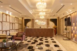a lobby with a salon with a chandelier at The Orlov in Babarpur