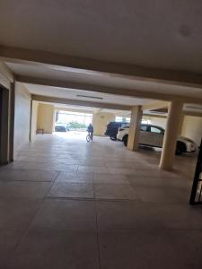 an empty parking garage with cars parked in it at Studio VIP - 01 chambre - Bonamoussadi groupe électrogène - 2douches in Douala