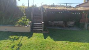 a set of stairs leading up to a yard with chairs at Il Paradiso Segreto in Pistoia +6 photos
