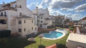 an external view of a building with a swimming pool at Lila in Ayamonte