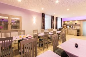 a restaurant with tables and chairs and a kitchen at Wasmayr Hof in Landshut