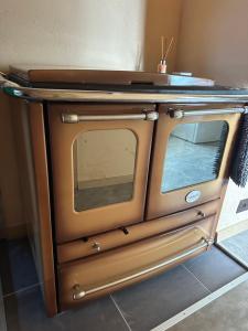 a small oven sitting in the corner of a room at Bruno māja in Strenči +4 photos