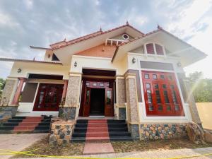 a house with red and white doors at An Haven Villa in Phú Xá