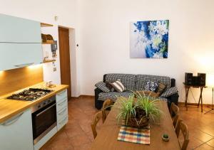 a kitchen and living room with a table and a couch at Guglielmo room's B&B in Catania