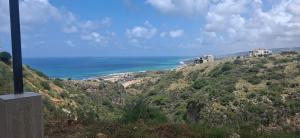 a view of the ocean from a hill at Honey Chalet in Al Khayyām
