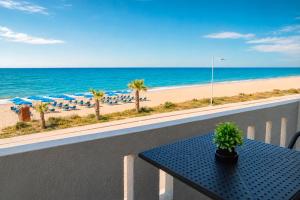 a table on a balcony with a view of the beach at Star Apartments in Rethymno
