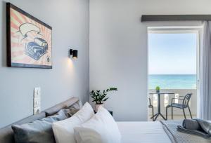 a bedroom with a bed and a couch and a table at Star Apartments in Rethymno