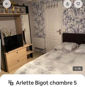 a bedroom with a bed and a dresser with a mirror at Arlette Guest House in Essarts