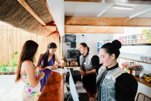 a group of women standing around a bar at Antuwanga reef resort in Moalboal