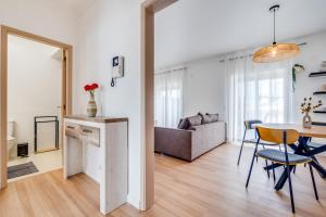 a living room with a table and a couch at Albufeira prime stay in Albufeira