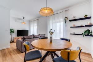 a living room with a table and a couch at Albufeira prime stay in Albufeira