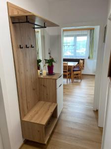 a room with a wooden cabinet with a bench at Das Sunnhäusl in Mariapfarr +16 photos