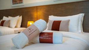 a hotel room with two towels on a bed at Bustan Alsafia بستان الصافية in Nizwa +43 photos