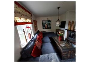 a living room with a blue couch and a table at Kulla Gard in Ingarö
