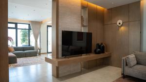 a living room with a flat screen tv on a wall at Bustan Alsafia بستان الصافية in Nizwa