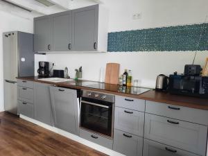 a kitchen with stainless steel appliances and wooden counters at Gemütliche Ferienwohnung Traumfänger NOK in Schafstedt +23 photos