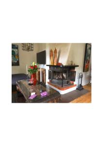 a living room with a couch and a fireplace at Kulla Gard in Ingarö +11 photos
