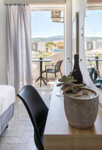 a room with a table with a plant on it at Star Apartments in Rethymno