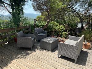 a deck with two chairs and a table and chairs at Mobile-home in Gassin