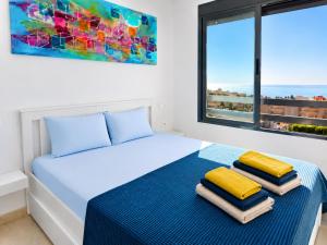 a bedroom with a bed with two pillows on it at Penthouse with Panoramic View Santa Pola in Santa Pola