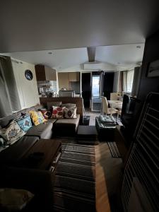 a living room with a couch and a table at Mobile-home in Gassin