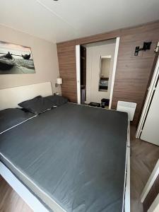 a bedroom with a large bed in a room at Mobile-home in Gassin