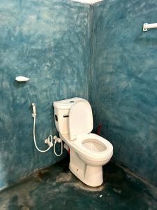 a bathroom with a white toilet in a room at Summer wave kudawa and Kite surfing school in Kalpitiya +44 photos
