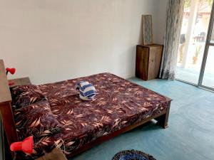 a bedroom with a bed with a pillow on it at Summer wave kudawa and Kite surfing school in Kalpitiya