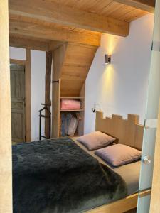 a bedroom with a large bed in a room at Le Menes in Andenne